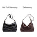 Dumpling Polyurethane Tote Bag - A black polyurethane tote bag with hot foil stamping and a brown polyurethane tote bag with debossing. Both have shoulder straps.