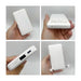 10000mAh Slim  Power Bank with Charging Cable - A white 10,000mAh slim power bank held in hand, featuring a built-in charging cable and various ports.