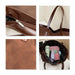 Suede Leather Tote Bag - A brown suede leather tote bag with a zip closure and various items inside, including pastel-coloured accessories.