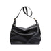 Dumpling Polyurethane Tote Bag - A black polyurethane tote bag with a soft, slouchy design and an adjustable shoulder strap.