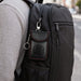 Carbon Fibre Faraday Key Pouch - A black carbon fibre Faraday key pouch with red trim attached to a backpack.