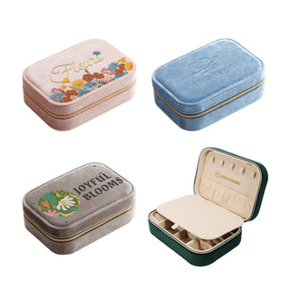 Velvet Jewellery Box with Compartment - A collection of velvet jewellery boxes in pink, blue, grey, and green, featuring compartments and branding.