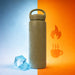 350ML/500ML Double Wall Stainless Steel Drink Bottle with Handle - A drink bottle in beige stainless steel with a handle, surrounded by ice cubes against a contrasting blue and orange background.