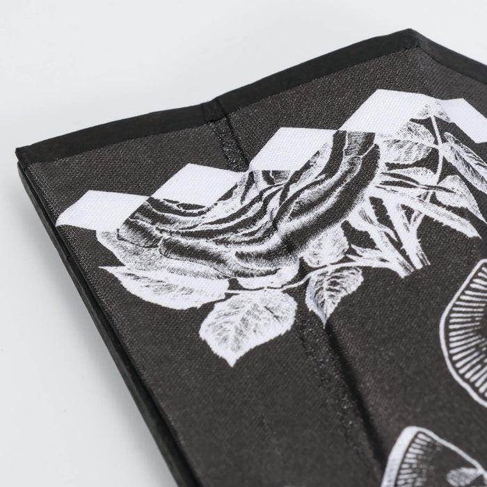 8inch Bamboo Fabric Hand Fan - A bamboo fabric hand fan in black with white floral designs and a slim, folded structure. It features branding.