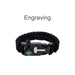 5 in 1 Survival Bracelet - A black survival bracelet featuring a compass and buckle, made from durable woven material. It includes a logo.