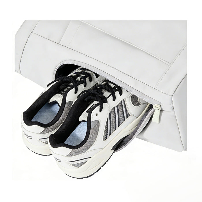 Lightweight Tennis Tote Bag - A lightweight tennis tote bag in white with a zippered compartment holding a pair of sneakers. It features a logo.