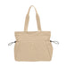 Lightweight Tote Bag With Yoga Mat Straps - A beige tote bag with yoga mat straps and side pockets. It features two handles and includes a logo.