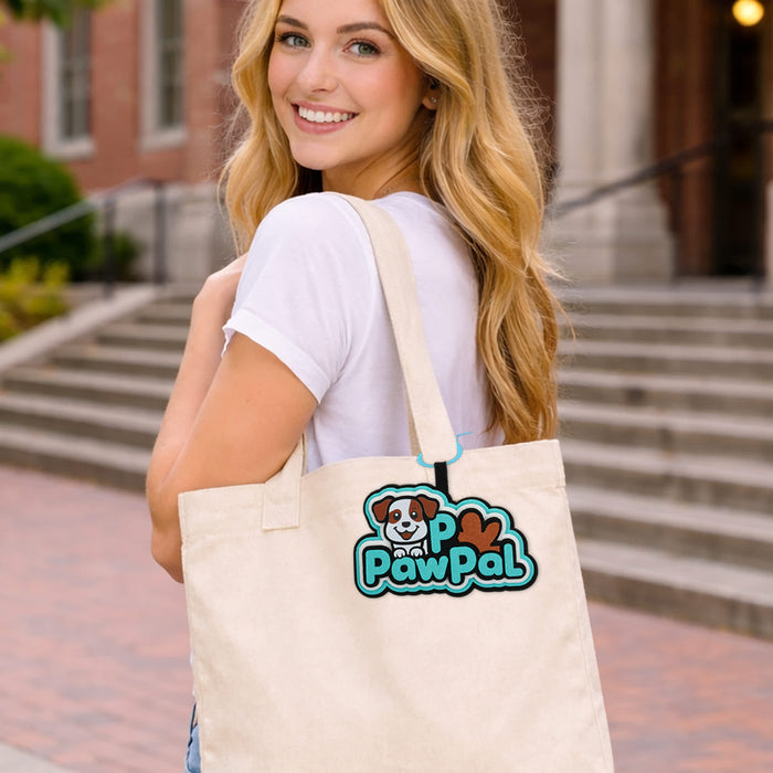 Custom Felt Hanging Tag - A woman carries a cream-coloured tote bag featuring a colourful logo with a dog design.