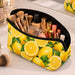 Neoprene Cosmetic Bag - A yellow neoprene cosmetic bag filled with makeup brushes and various cosmetic products, featuring a lemon design.
