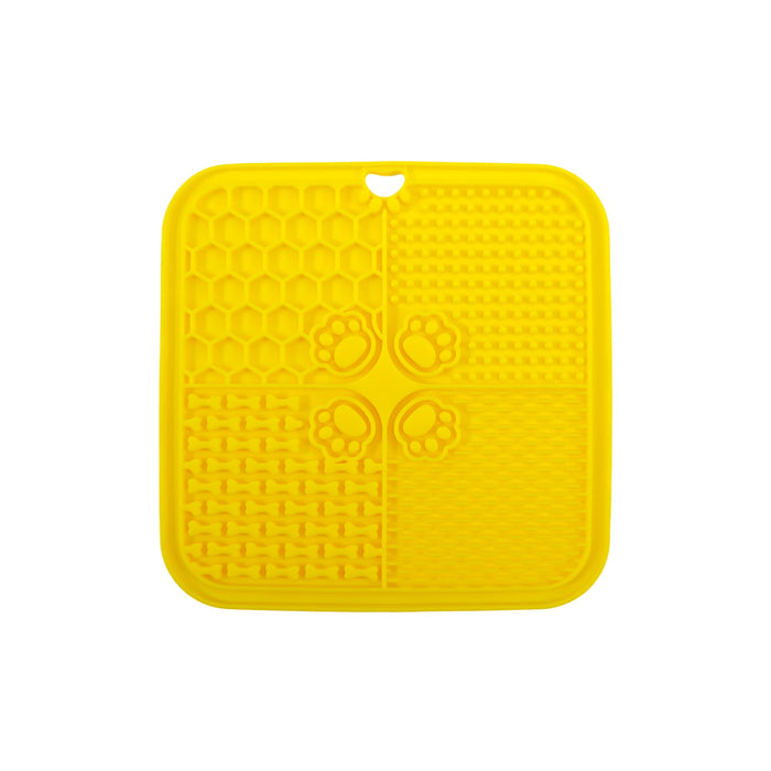 4-Section Dog Enrichment Lick Mat - A yellow, four-section silicone lick mat featuring textured patterns and paw prints, with a hole for hanging.
