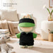 Plush Doll Racing Suit Set (15–17cm Doll) - A plush doll racing suit set in green and black, displayed on a soft rug with a teddy bear nearby.