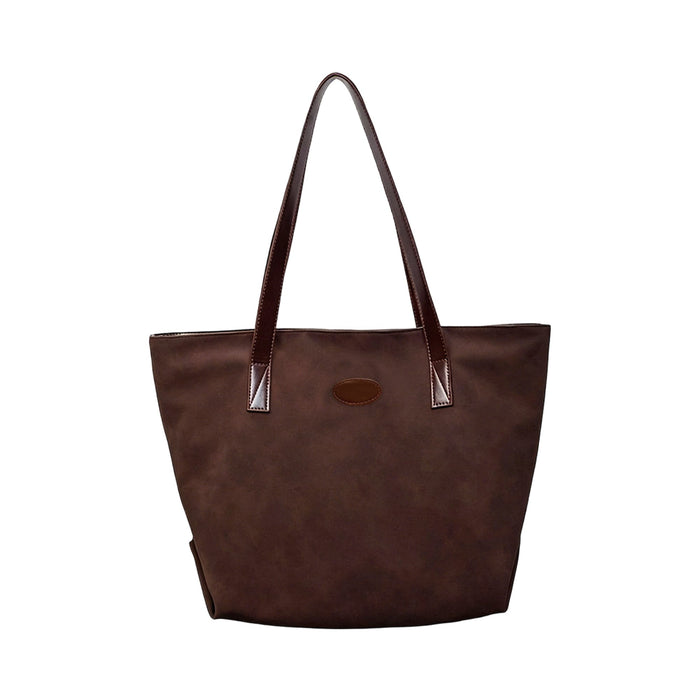 Suede Leather Tote Bag - A brown suede leather tote bag with dark leather handles and a branding logo.
