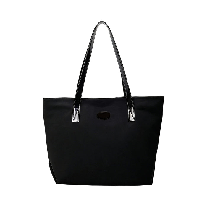 Suede Leather Tote Bag - A black suede leather tote bag with long black handles and a simple design, featuring a logo.