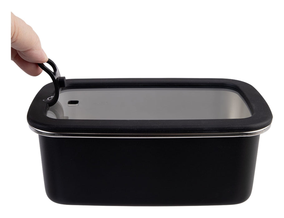 Oasis Microwave Safe Rectangular S/S Container 1.1L - A hand holding the lid of a black rectangular stainless steel container with a clear plastic top.