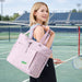 Lightweight Tennis Tote Bag - A lightweight tennis tote bag in pastel pink, featuring a front pocket and straps, carried by a model on a tennis court.
