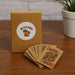 Eco Playing Cards - A deck of eco-friendly playing cards in brown packaging with a logo, showcasing several cards with colourful designs.
