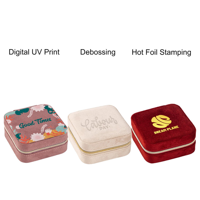 Velvet Jewellery Organizer - Three square velvet jewellery organisers in pink, cream, and red with decorative designs and a logo on each.