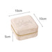 Velvet Jewellery Organizer - A velvet jewellery organiser in ivory, measuring 10cm x 10cm x 5cm, with a zip closure and a subtle logo.