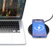 Casper Pro 15 Watt Eco Wireless Charger - A black wireless charger with a smartphone displaying a charging indicator, beside a laptop with a natural backdrop.