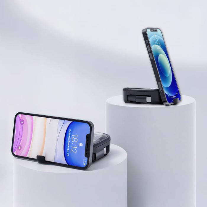 Catania Retractable 60W Fast Charging and Data Cable Set - A mobile phone stand in black, holding a smartphone, displayed on white pedestals against a light background.