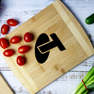 Trey Bamboo Cutting Board - A bamboo cutting board displaying a logo, with cherry tomatoes and chopped spring onions alongside it.