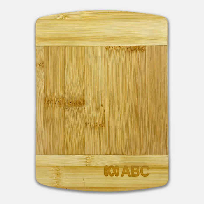 Tiga Bamboo Cutting Board - A bamboo cutting board featuring a smooth surface with a rectangular shape and a small logo on one side.