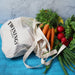 Maglia Cotton Shopping Tote - A cotton shopping tote in cream with a mesh top, filled with carrots, radishes, and fresh herbs.