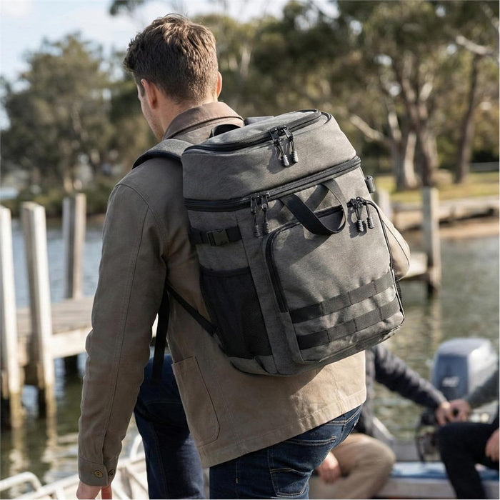 Super Duty 30 - Backpack Cooler - A grey backpack cooler, with multiple compartments, being carried by a person near a waterfront.