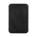 Wally Stand - A black phone wallet with a circular magnet feature on the back. It has a textured surface and a simple design.