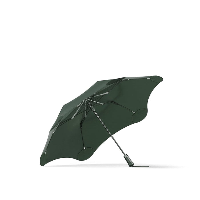 BLUNT Metro Umbrella - A green BLUNT Metro Umbrella with a distinctive shape and a metallic handle, featuring a logo on the canopy.