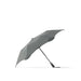 BLUNT Metro Umbrella - A grey BLUNT Metro Umbrella with a sleek, aerodynamic design and a branding logo on the handle.