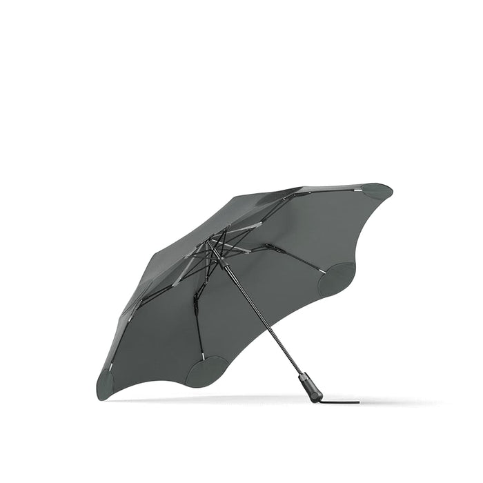 BLUNT Metro Umbrella - A grey BLUNT Metro Umbrella with a sleek design and a sturdy frame. It features a branding logo.