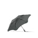 BLUNT Metro Umbrella - A grey BLUNT Metro Umbrella with a sleek design and a sturdy frame. It features a branding logo.