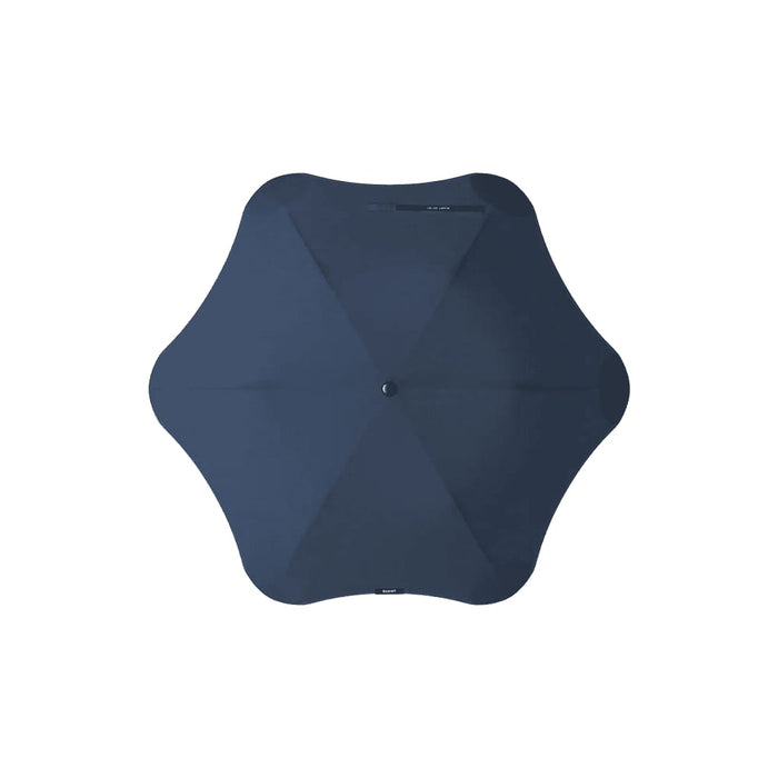 The Blunt Umbrella All Weather Set - A navy BLUNT Metro Umbrella with a unique octagonal shape and a central button, featuring a logo.