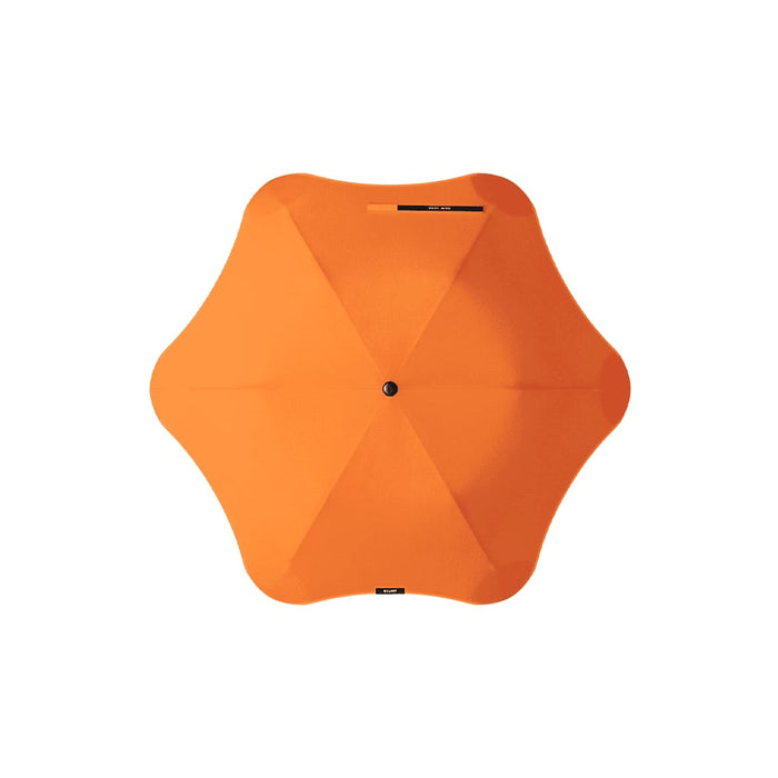 BLUNT Metro Umbrella - An orange BLUNT Metro Umbrella with a unique octagonal shape and central button for opening and closing.
