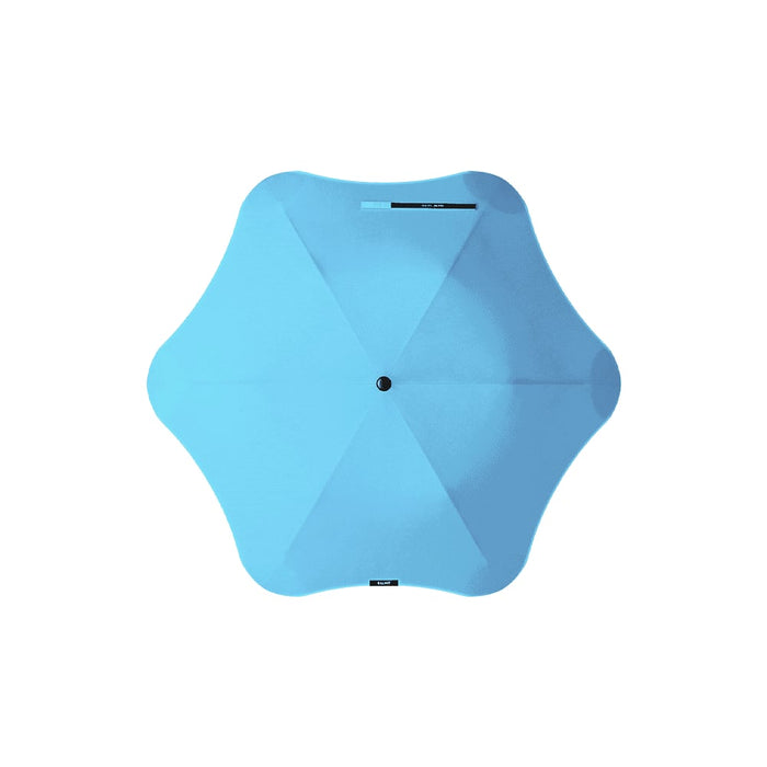 BLUNT Metro Umbrella - A blue BLUNT Metro Umbrella with a unique star shape and a central button mechanism. It features branding on the canopy.