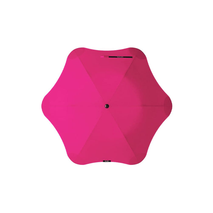 BLUNT Metro Umbrella - A pink BLUNT Metro Umbrella with a unique shape and a central button for opening and closing.