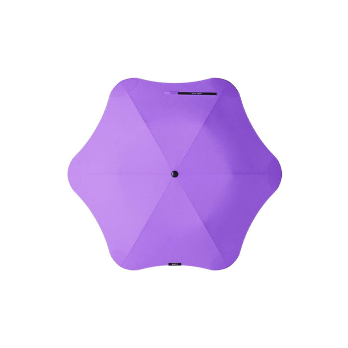 BLUNT Metro Umbrella - A purple BLUNT Metro Umbrella with a unique octagonal shape and a central button. The umbrella features a branding logo.
