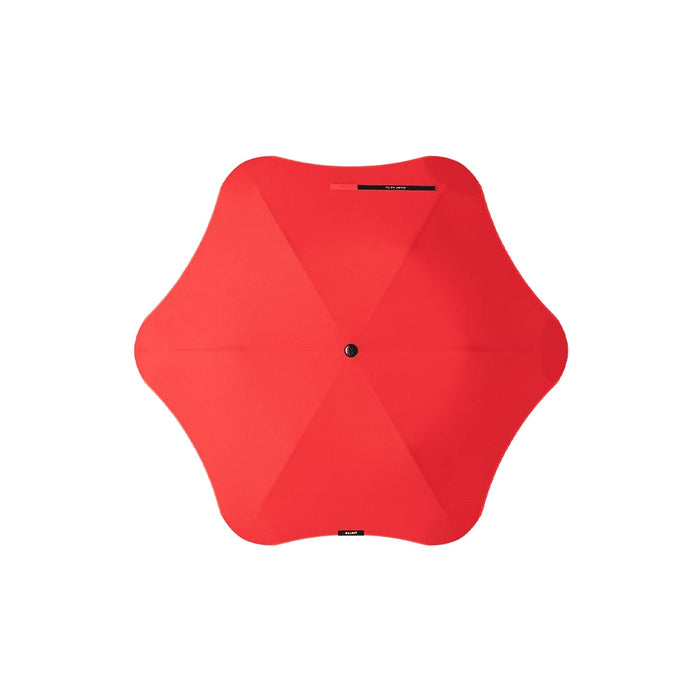 BLUNT Metro Umbrella - A red umbrella with an octagonal shape and a central button, featuring a simple design and a branding logo.