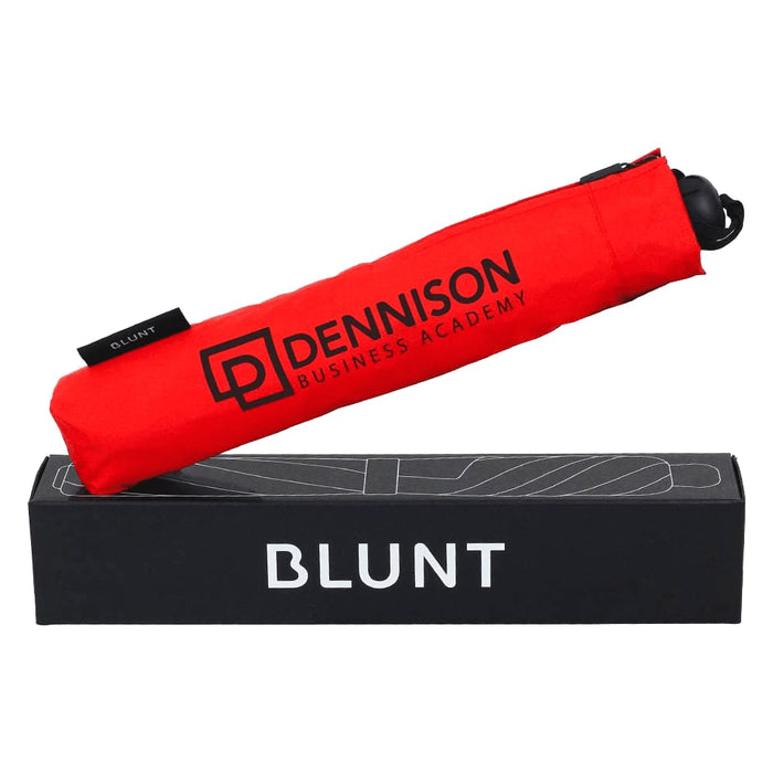 BLUNT Metro Umbrella - A red BLUNT Metro Umbrella in its packaging, featuring a logo on the cover.