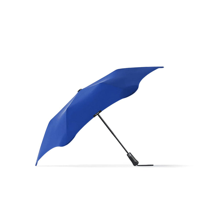 BLUNT Metro Umbrella - A blue BLUNT Metro Umbrella with a sleek design and a black handle, featuring a branding logo.