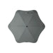 BLUNT Classic Umbrella - A grey BLUNT Classic Umbrella with a unique star-like shape and a central button. It features a logo.