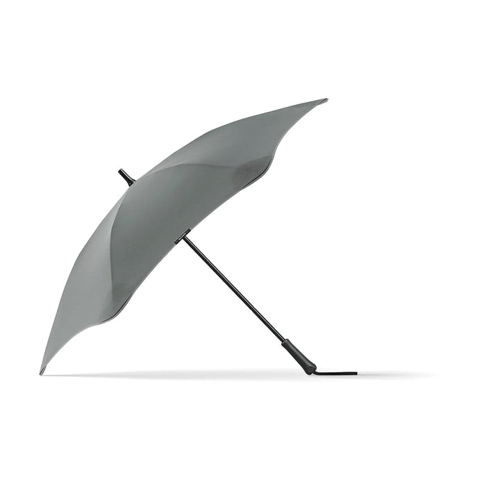 BLUNT Classic Umbrella - A grey BLUNT Classic Umbrella with a unique, aerodynamic shape and a curved canopy, featuring a logo on the handle.