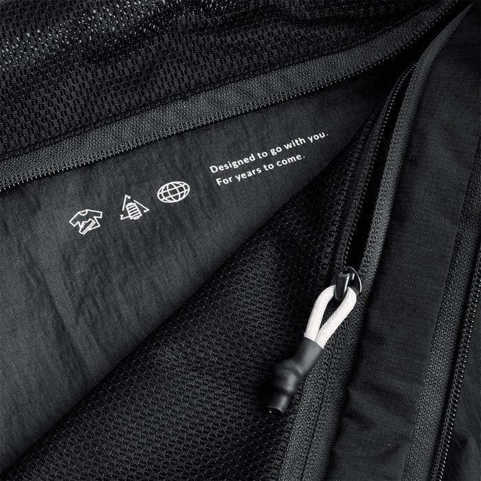 Bellroy Lite Packing Cube 12L - A black packing cube with a mesh panel and zip closure, featuring a subtle logo and design details.