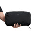 Bellroy Lite Packing Cube 12L - A black packing cube being held by a person, featuring a zippered closure and a small logo on the front.