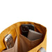 Bellroy City Tote - A yellow tote bag interior with two pockets holding a drink bottle and two smartphones.
