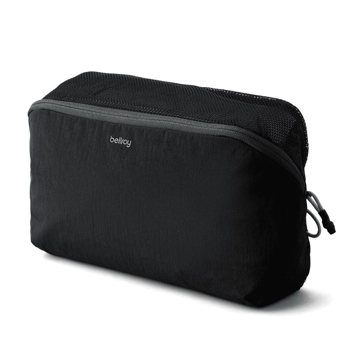 Bellroy Lite Packing Cube 6L - A black packing cube with a zippered mesh top, featuring branding on the front.