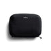 Bellroy Lite Tech Kit - A black tech kit with a zip closure and a logo on the front, featuring a sleek, minimalist design.