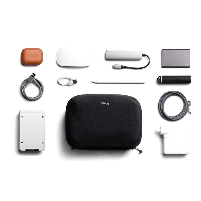Bellroy Lite Tech Kit - A black tech kit containing a range of accessories, including a charger, cables, and a portable hard drive.