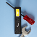 Rechargeable Work Light - A rechargeable work light in black with a yellow light panel, alongside a red screwdriver and a silver wrench.